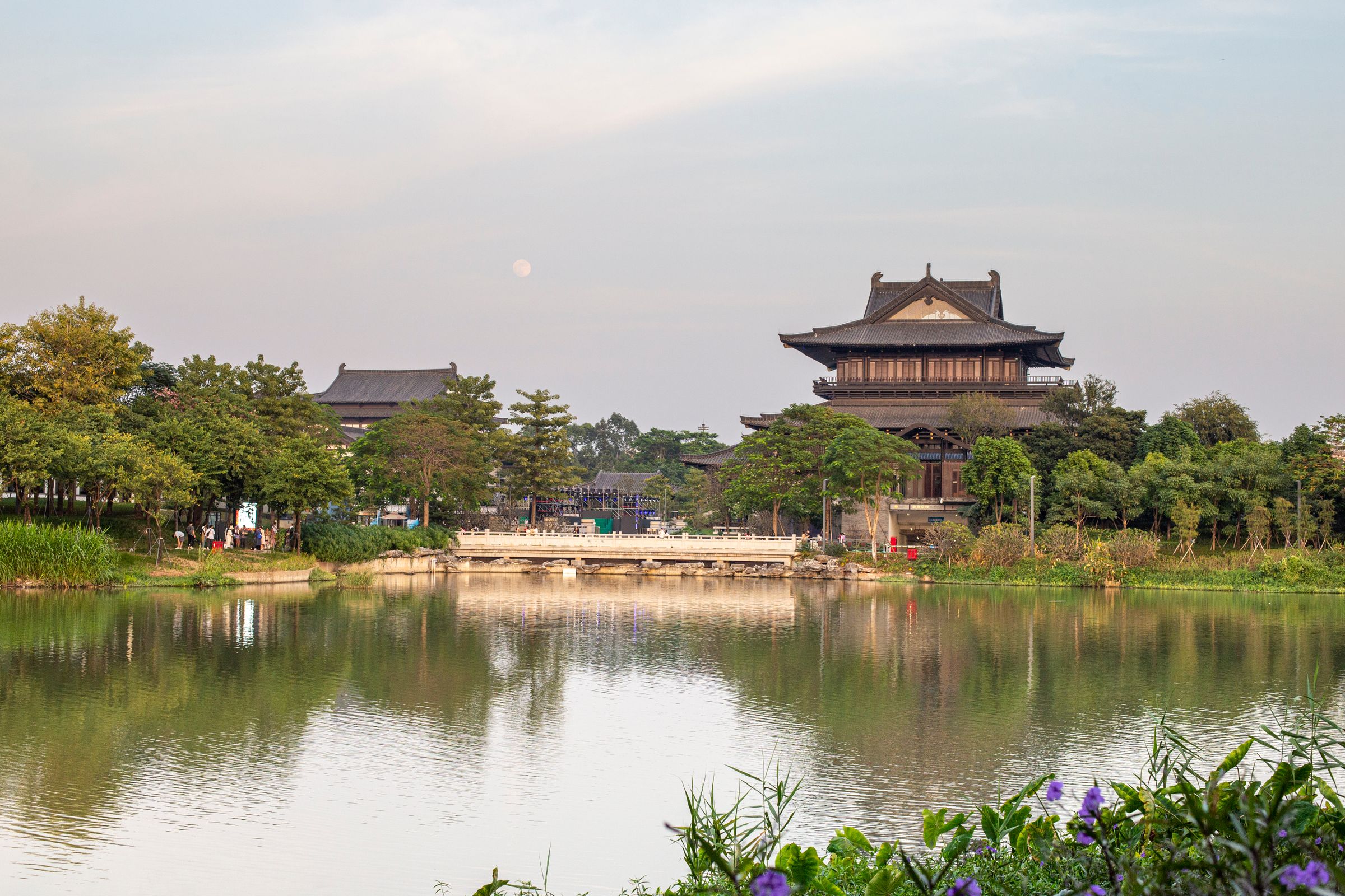 Traditional buildings and a footbridge reflected in Haizhu Lake, Guangzhou